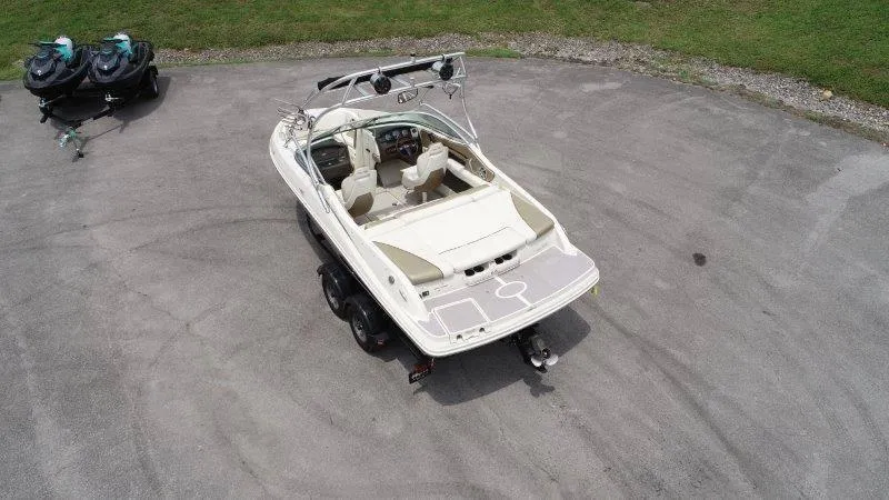 Slide: The Image of 2007 Sea Ray 210 Select boat on trailer, aerial view, parked on concrete surface. - 8