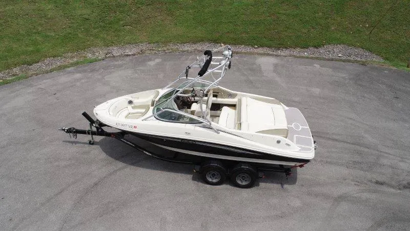 Slide: The Image of 2007 Sea Ray 210 Select boat on trailer, parked on paved surface, aerial view. - 9