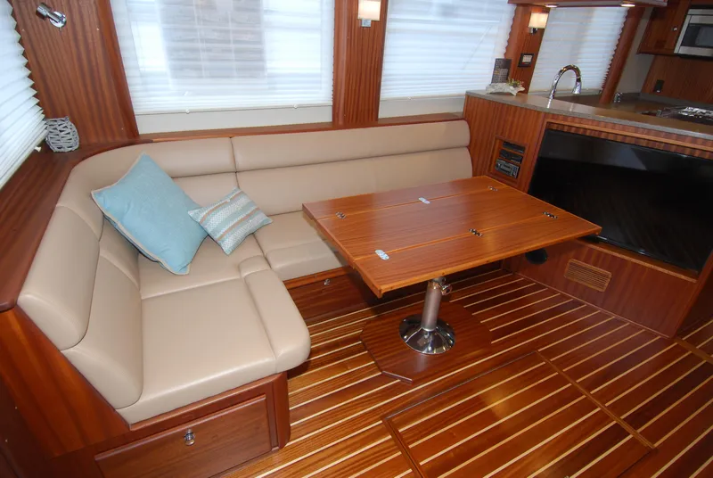 Slide: The Image of Luxurious interior of 2015 American Tug 485 with leather seating and wooden table. - 15