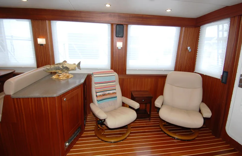 Slide: The Image of Interior of 2015 American Tug 485 with cozy seating and wood paneling. - 17