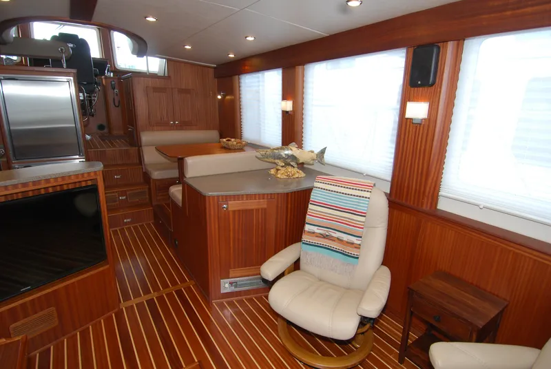 Slide: The Image of Luxurious interior of 2015 American Tug 485 with wood paneling and comfortable seating. - 21