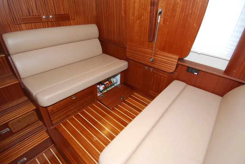 Slide: The Image of Interior of 2015 American Tug 485 with wood paneling and beige seating. - 28