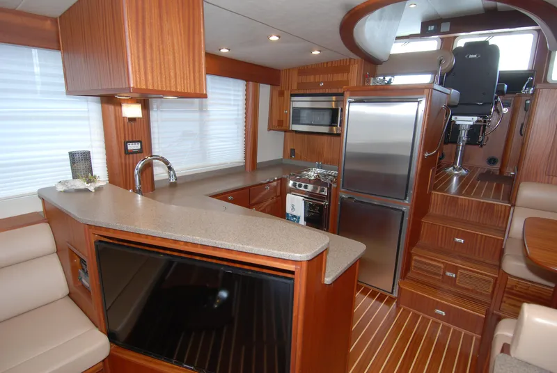Slide: The Image of Luxurious 2015 American Tug 485 interior with modern kitchen and seating area. - 30