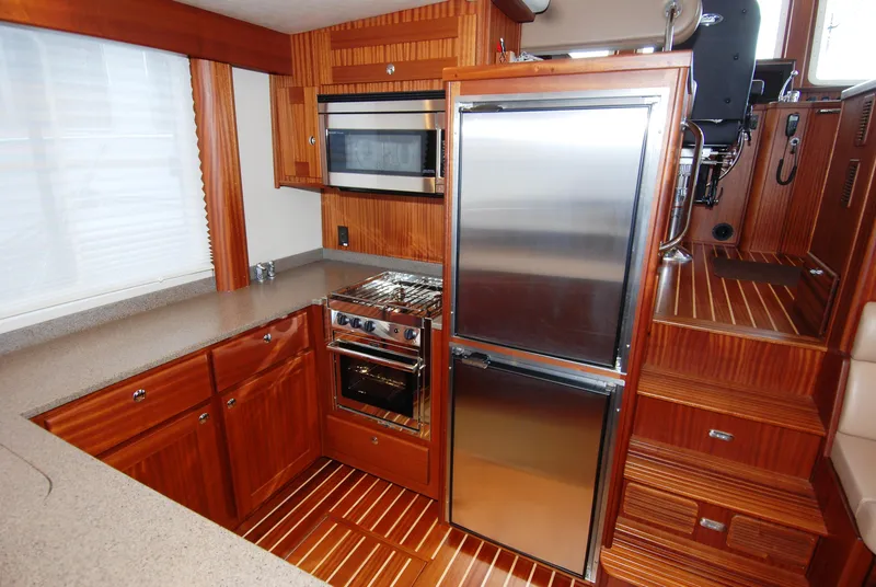 Slide: The Image of Luxurious 2015 American Tug 485 kitchen with wood cabinetry, stainless steel appliances, and modern design. - 35