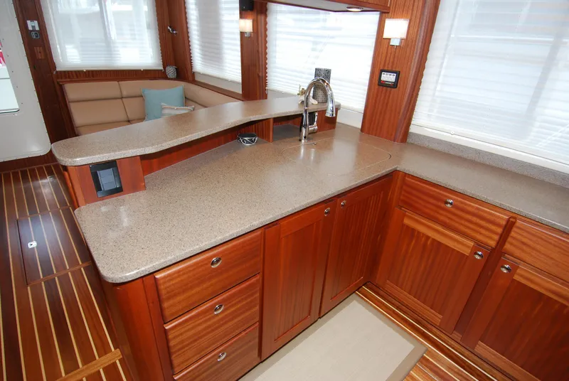 Slide: The Image of Luxurious 2015 American Tug 485 interior with elegant wood cabinetry and modern kitchen amenities. - 36