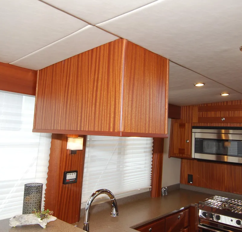 Slide: The Image of Interior of 2015 American Tug 485 yacht with modern kitchen design and wood finishes. - 38