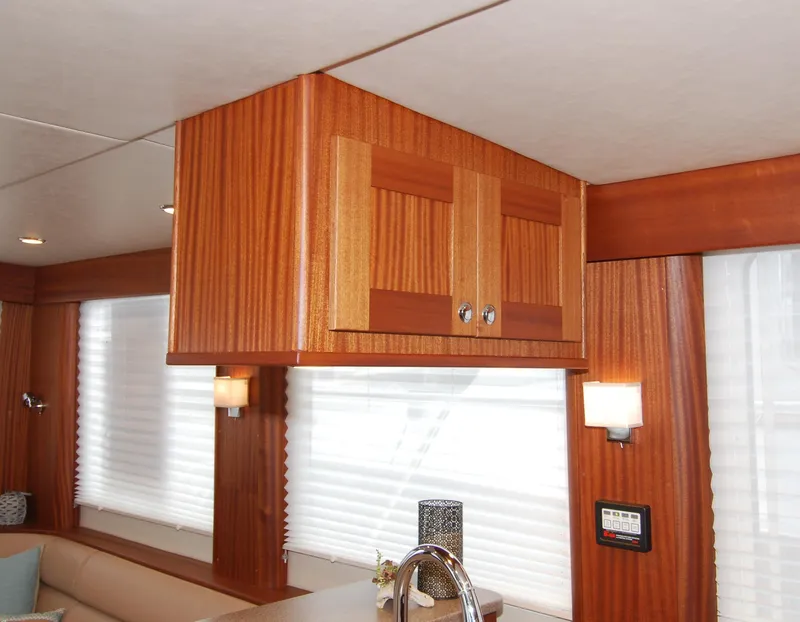 Slide: The Image of Interior of 2015 American Tug 485 with wooden cabinetry and modern lighting. - 40