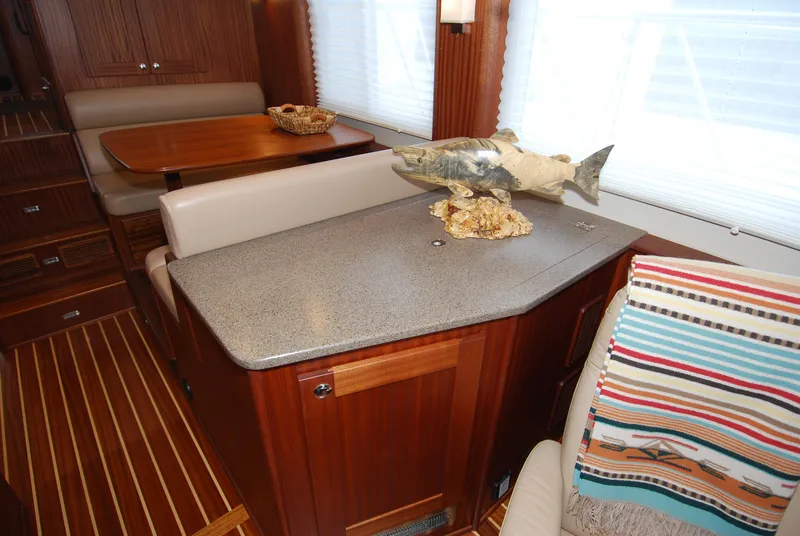 Slide: The Image of Interior of 2015 American Tug 485 with wooden cabinetry and fish sculpture on countertop. - 41