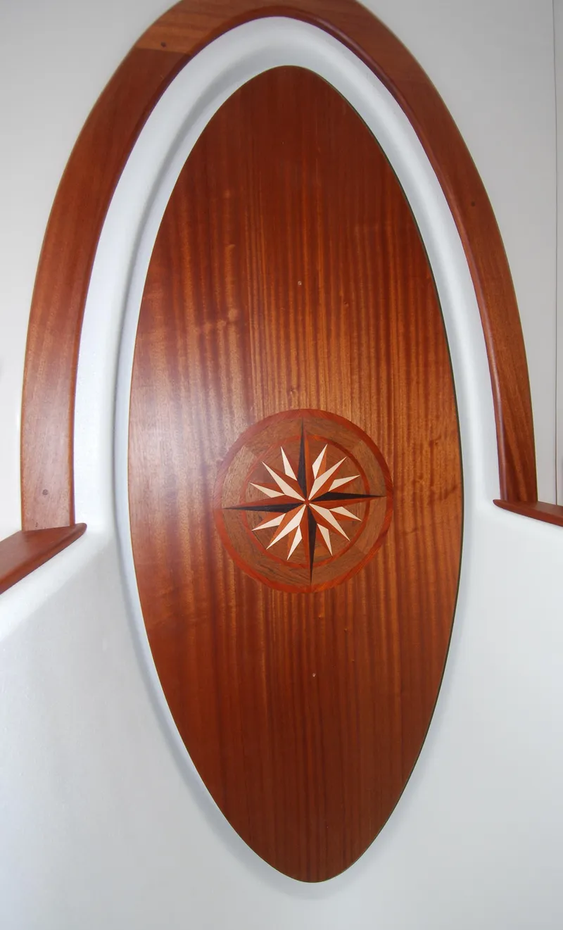 Slide: The Image of Wooden interior detail on 2015 American Tug 485 boat, featuring a compass rose design. - 43
