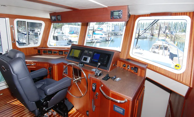 Slide: The Image of Pilothouse of 2015 American Tug 485 with navigation equipment and marina view. - 46