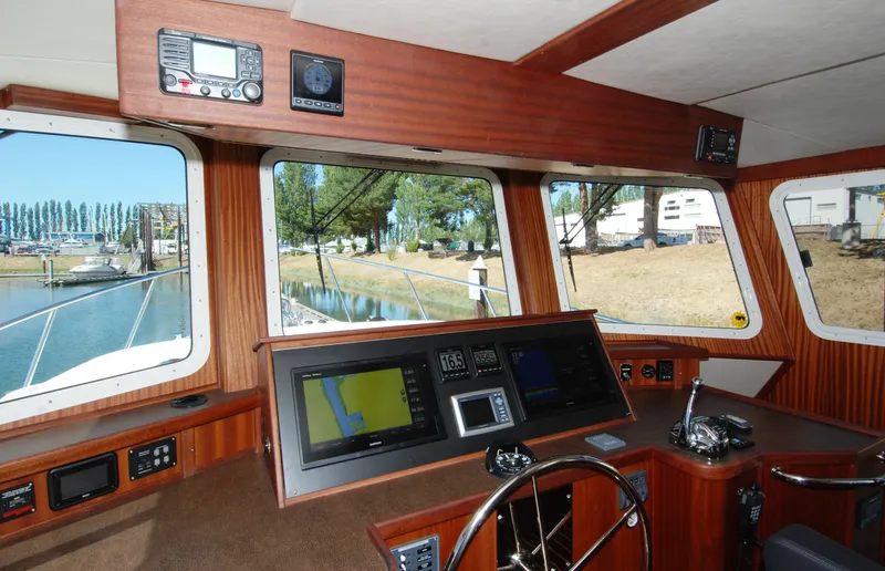 Slide: The Image of Pilothouse of 2015 American Tug 485 with navigation equipment and large windows. - 49