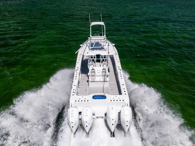 Slide: The Image of Freeman 37 VH 2023 boat cruising on open water, rear view, powerful engines. - 11