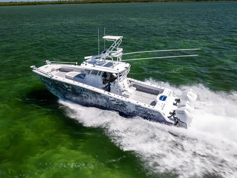 Slide: The Image of 2023 Freeman 37 VH boat cruising on vibrant green water, showcasing sleek design and powerful engines. - 12