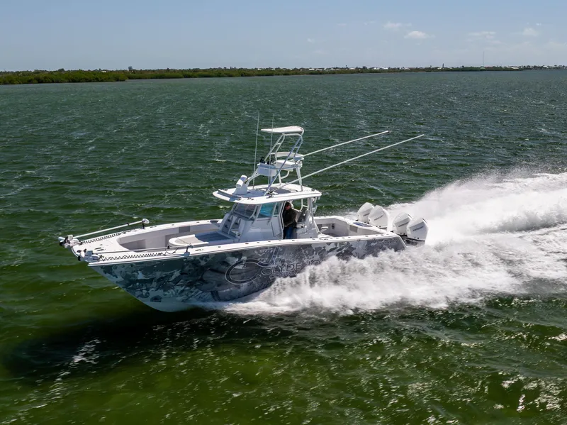 Slide: The Image of 2023 Freeman 37 VH boat speeding on open water, showcasing sleek design and powerful performance. - 15