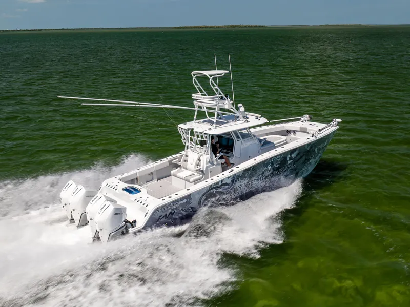 Slide: The Image of 2023 Freeman 37 VH boat cruising on open water, showcasing powerful twin engines. - 17