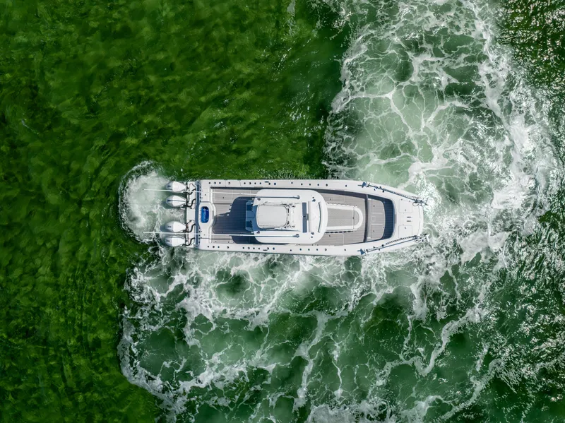 Slide: The Image of Aerial view of 2023 Freeman 37 VH boat navigating through green waters. - 18