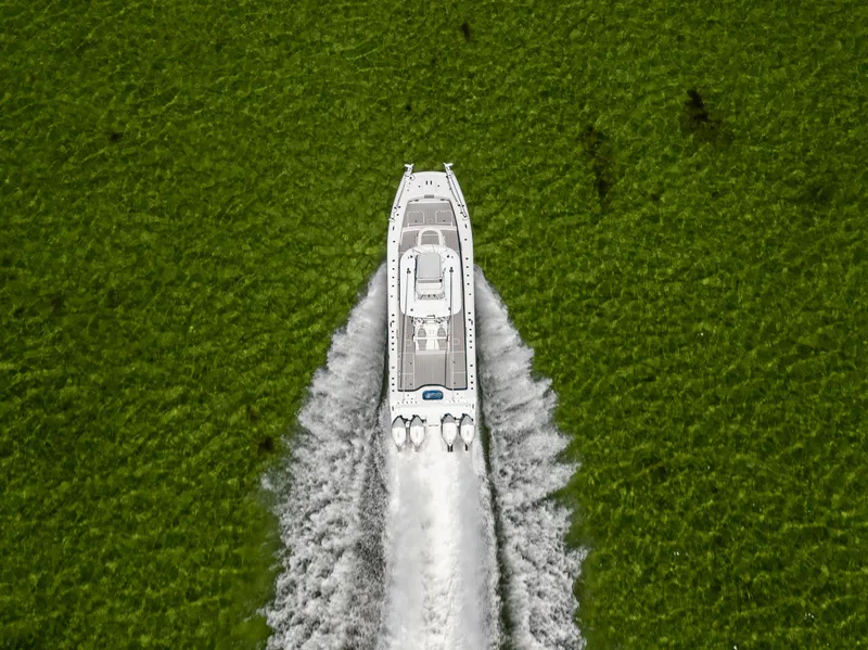 Slide: The Image of Aerial view of 2023 Freeman 37 VH boat cruising through vibrant green waters. - 19