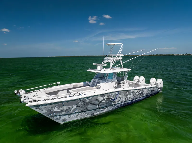 Slide: The Image of 2023 Freeman 37 VH boat on green water under clear blue sky. - 2