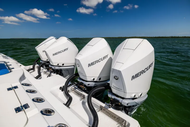 Slide: The Image of Triple Mercury outboard engines on a 2023 Freeman 37 VH boat in open water. - 20