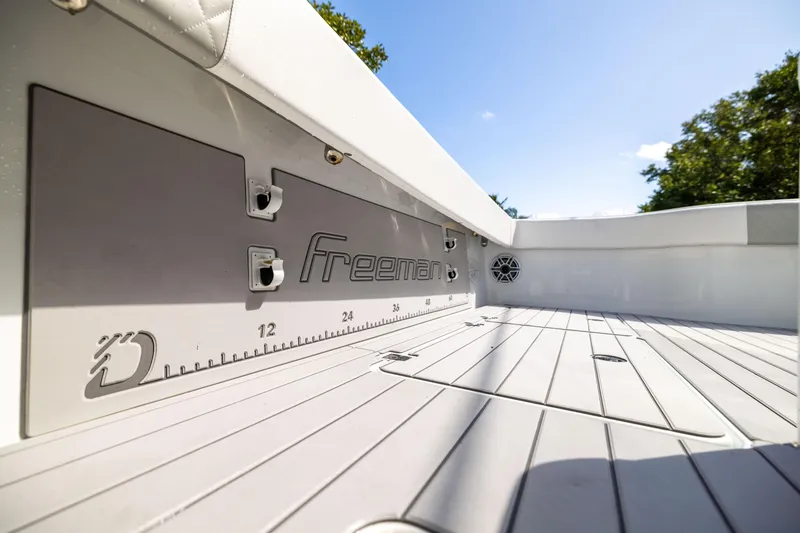 Slide: The Image of Freeman 37 VH 2023 boat deck with measurement markings and speaker, under clear sky. - 32