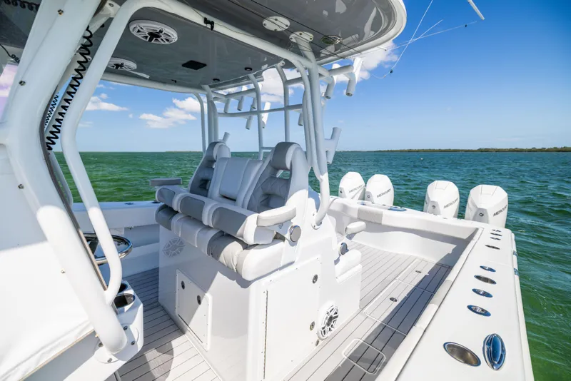 Slide: The Image of 2023 Freeman 37 VH boat interior with seating and multiple outboard engines on open water. - 33