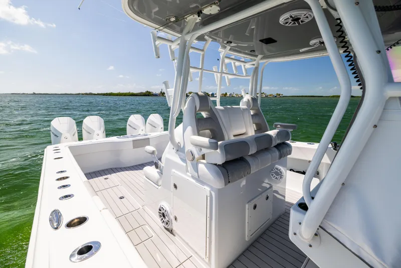 Slide: The Image of 2023 Freeman 37 VH boat interior with seating, ocean view, and multiple outboard engines. - 35