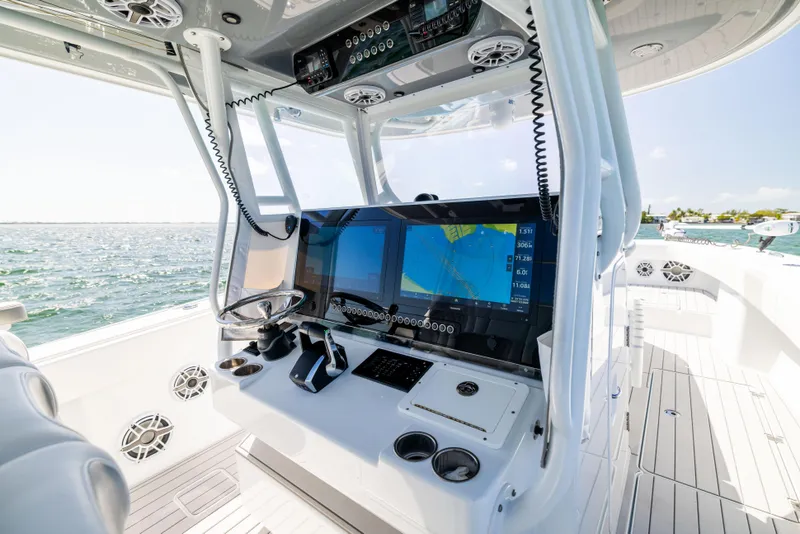 Slide: The Image of Freeman 37 VH 2023 boat cockpit with advanced navigation system and ocean view. - 37