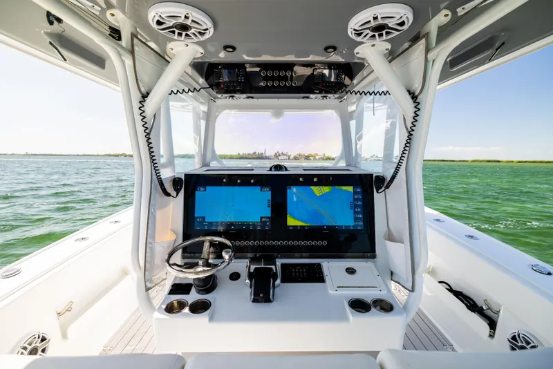 Slide: The Image of 2023 Freeman 37 VH boat cockpit with dual navigation screens on open water. - 39