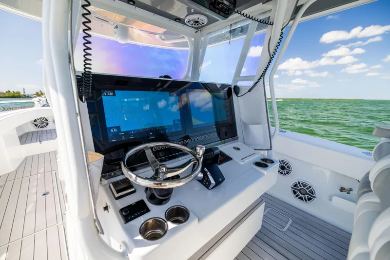 Slide: The Image of Modern helm of 2023 Freeman 37 VH boat with advanced navigation system, steering wheel, and ocean view. - 41