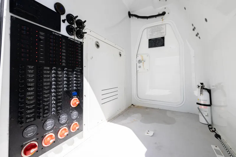 Slide: The Image of Electrical panel inside 2023 Freeman 37 VH boat, featuring control switches and safety equipment. - 42