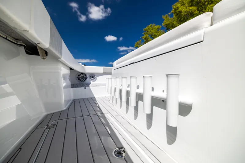 Slide: The Image of Freeman 37 VH 2023 boat interior with rod holders, sleek design, and clear blue sky. - 44
