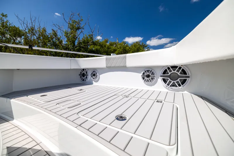Slide: The Image of Freeman 37 VH 2023 boat deck with speakers, under a clear blue sky. - 45