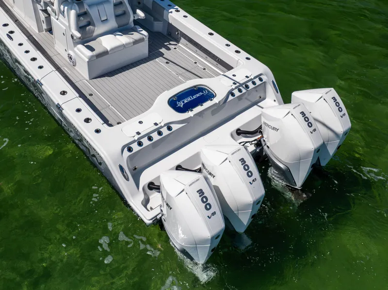 Slide: The Image of Freeman 37 VH 2023 boat with four powerful Mercury outboard engines on green water. - 9