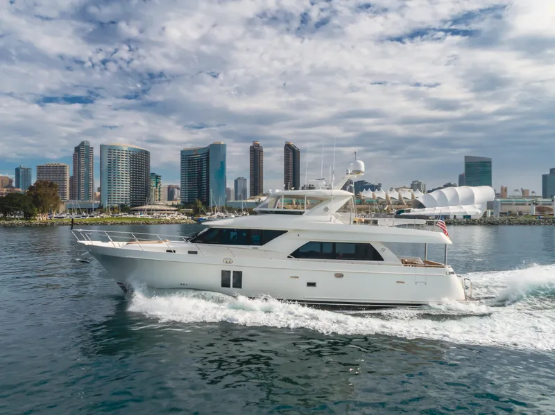 Slide: The Image of 2015 Ocean Alexander 72 yacht cruising near city skyline under cloudy sky. - 1