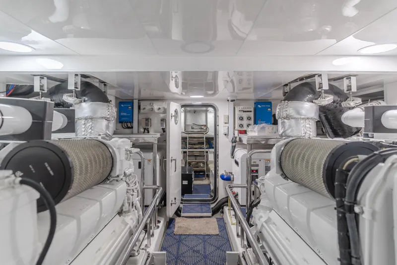 Slide: The Image of Engine room of 2015 Ocean Alexander 72 yacht, featuring dual engines and modern equipment. - 12