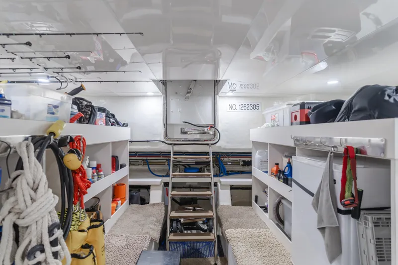 Slide: The Image of Storage area inside a 2015 Ocean Alexander 72 yacht, featuring shelves and equipment. - 14