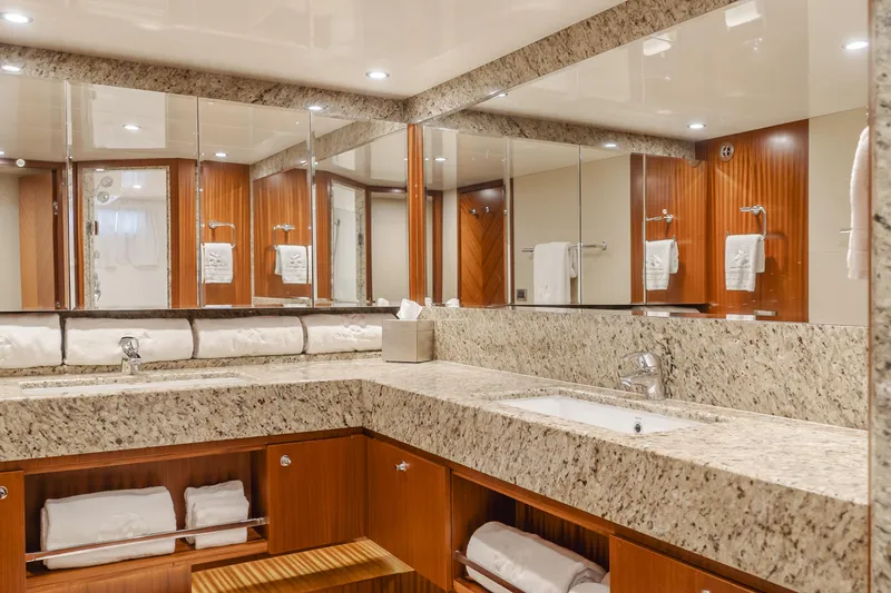 Slide: The Image of Luxurious bathroom in 2015 Ocean Alexander 72 yacht with granite countertops and wood accents. - 25