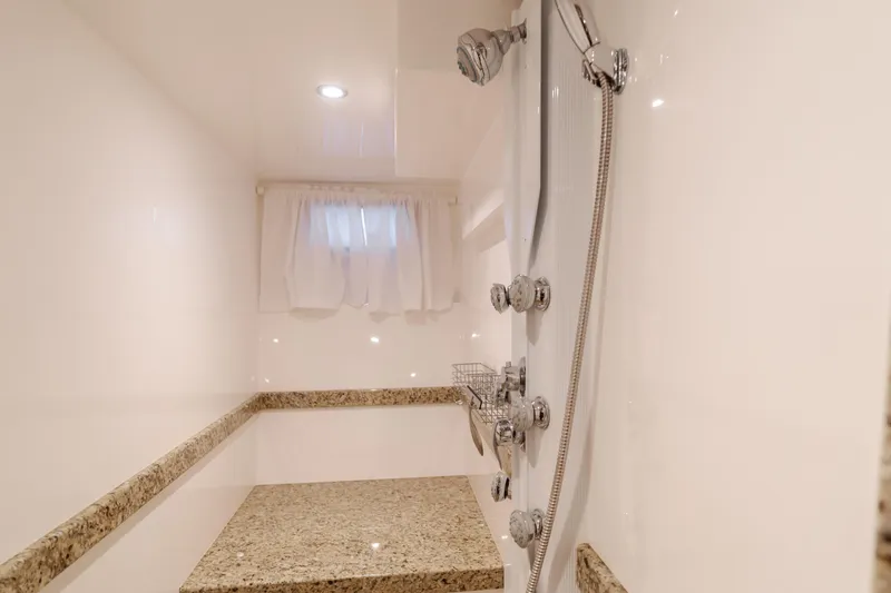 Slide: The Image of Luxurious shower in 2015 Ocean Alexander 72 yacht with granite bench and modern fixtures. - 26