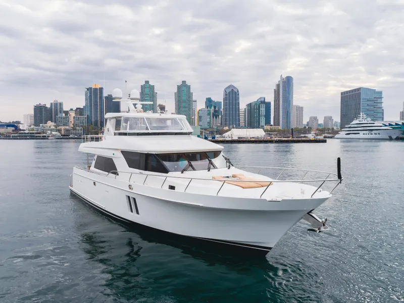 Slide: The Image of 2015 Ocean Alexander 72 yacht cruising near city skyline under cloudy skies. - 3
