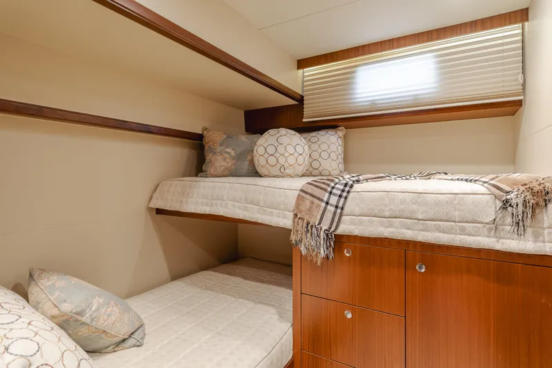 Slide: The Image of Bunk beds in 2015 Ocean Alexander 72 yacht cabin with wooden drawers and cozy decor. - 30