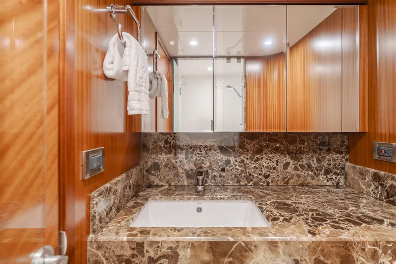 Slide: The Image of Luxurious bathroom in 2015 Ocean Alexander 72 yacht with marble countertop and wooden cabinetry. - 31