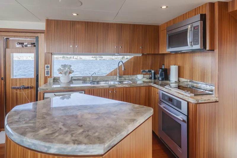 Slide: The Image of Luxurious kitchen interior of 2015 Ocean Alexander 72 yacht with modern appliances and wood finish. - 40