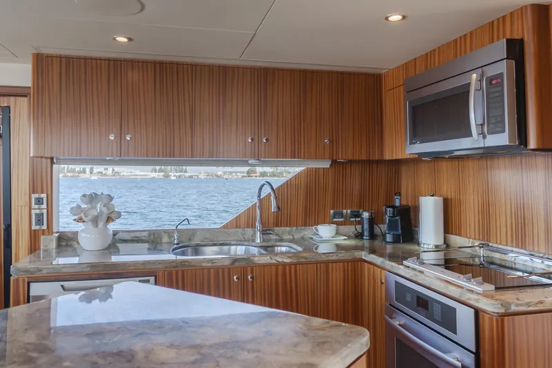 Slide: The Image of Luxurious kitchen interior of 2015 Ocean Alexander 72 yacht with modern appliances and wood finish. - 41