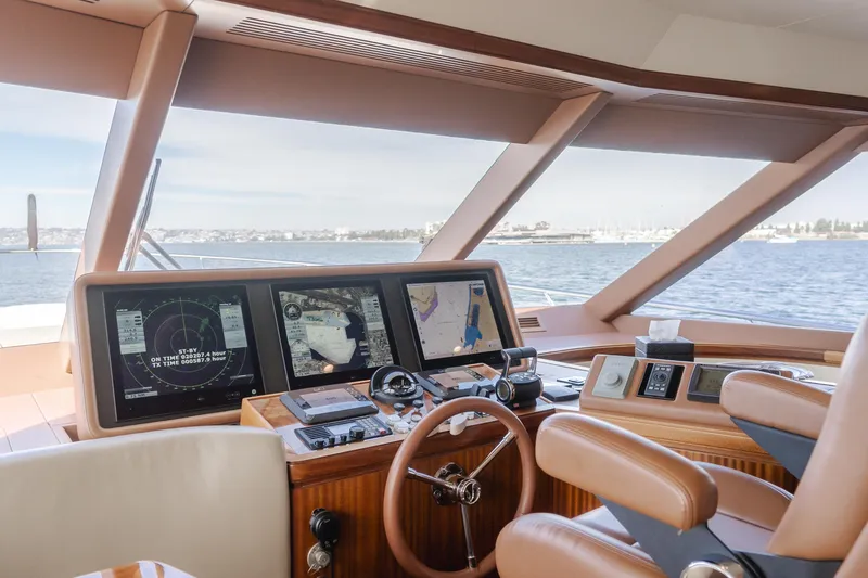 Slide: The Image of Helm of 2015 Ocean Alexander 72 yacht with navigation screens and steering wheel. - 43
