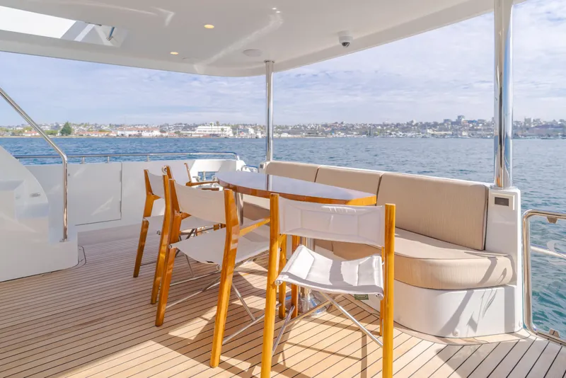 Slide: The Image of Luxurious 2015 Ocean Alexander 72 yacht deck with seating, overlooking serene waters. - 47