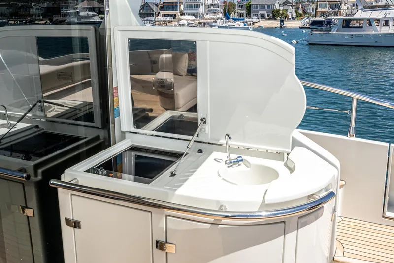 Slide: The Image of Outdoor sink area on 2009 Azimut 62S yacht, featuring sleek design and waterfront view. - 17