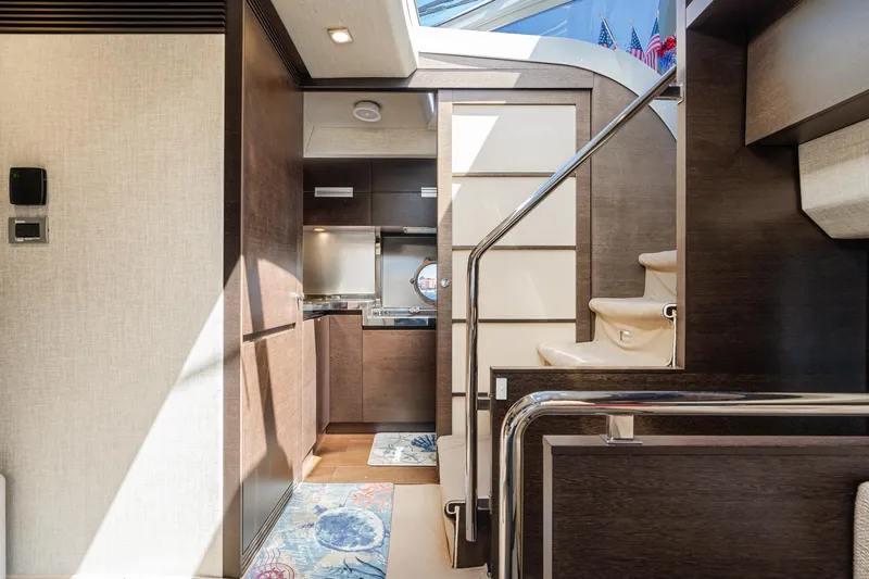 Slide: The Image of Interior of a 2009 Azimut 62S yacht, featuring modern kitchen and staircase. - 28