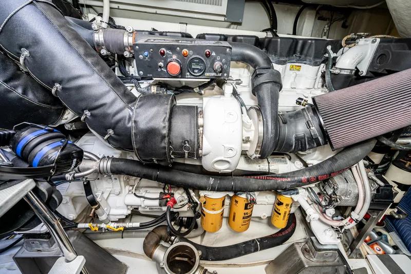 Slide: The Image of Engine room of a 2009 Azimut 62S yacht, showcasing detailed mechanical components. - 44