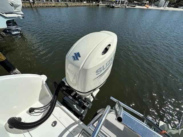 Slide: The Image of 2021 AmeraCat 27 Gen II DC with Suzuki outboard motor on a calm waterway. - 13