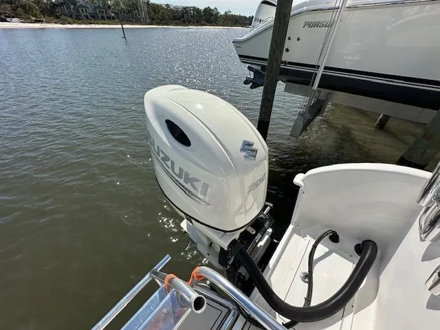 Slide: The Image of 2021 AmeraCat 27 Gen II DC with Suzuki outboard motor docked by the water. - 14